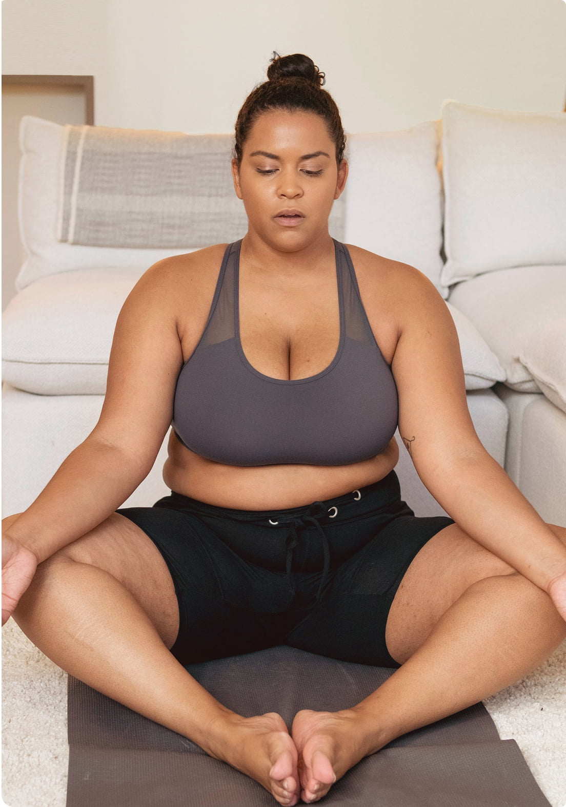 Woman in Sukhasana yoga pose with eyes closed